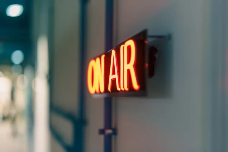 Bright red 'On Air' neon sign captured indoors, ideal for media content.