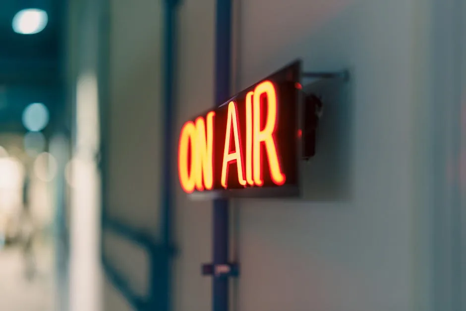 Bright red 'On Air' neon sign captured indoors, ideal for media content.