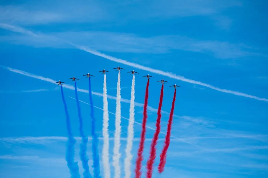 Patrouille de France jets performing an aerobatic display with colored smoke trails over Paris.