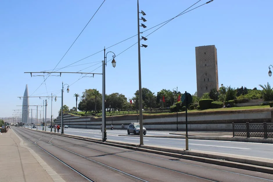 Wide-angle view of Rabat's streets with Hassan Tower visible, captured on a sunny day.