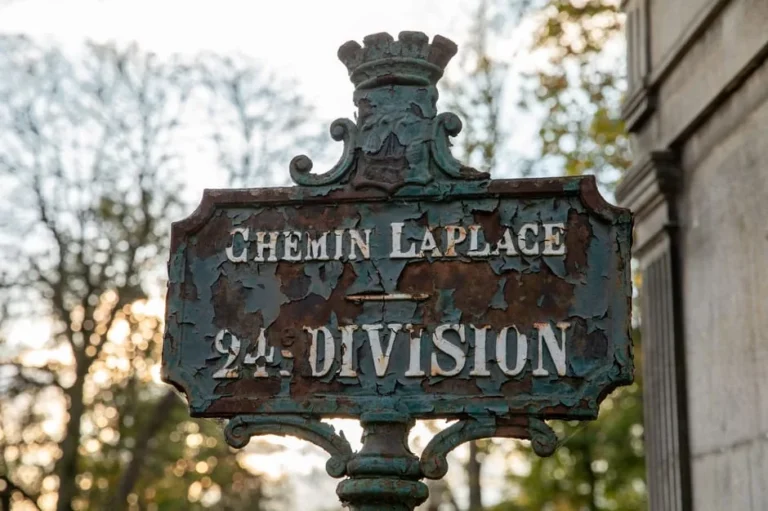Rustic signpost at Père Lachaise Cemetery in Paris, France.