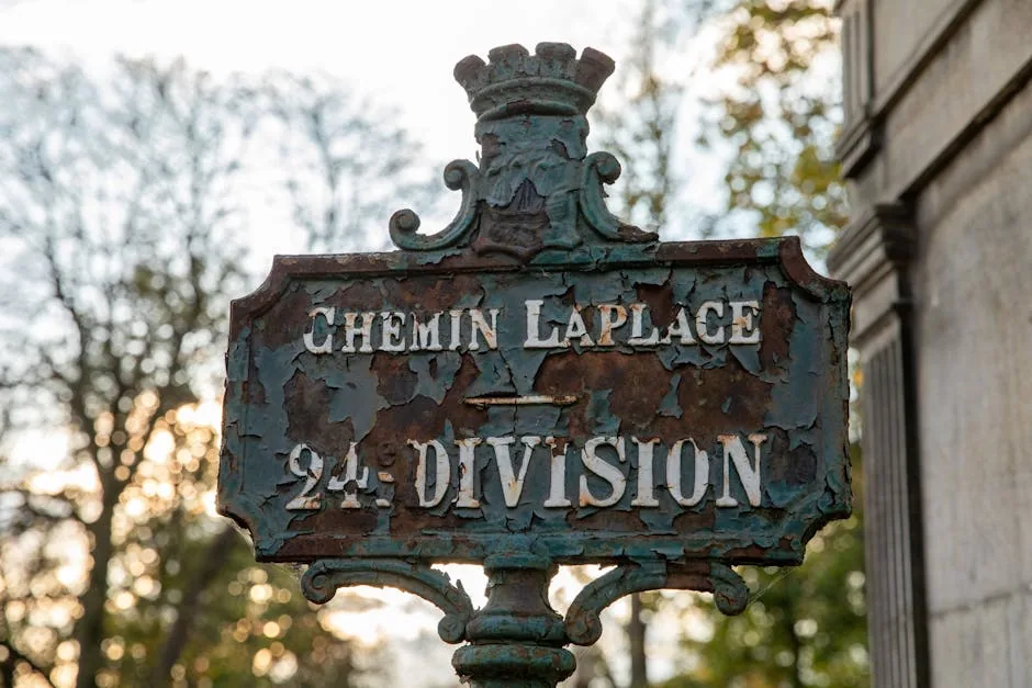 Rustic signpost at Père Lachaise Cemetery in Paris, France.