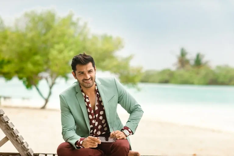 A fashionable man enjoying a tropical vacation on a pristine Maldivian beach.